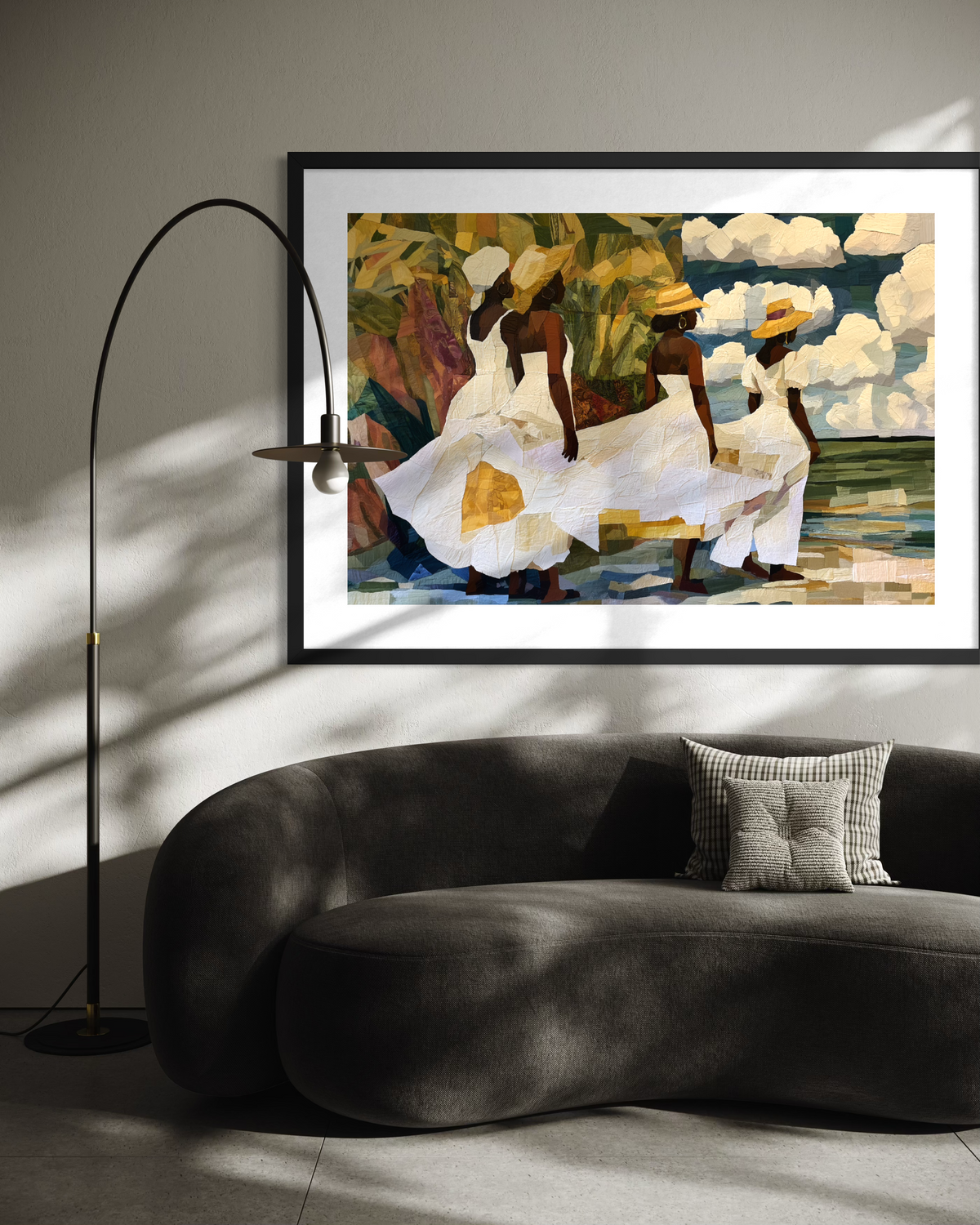 Framed fine art print depicting Afrocentric Gullah Geechee women dressed in white faux quilt-style patter dresses celebrating Black Low Country coastal heritage, African American ancestry, cultural traditions, family, community, and life rooted by the sea.  Displayed on a off-white wall above a dark green sofa.