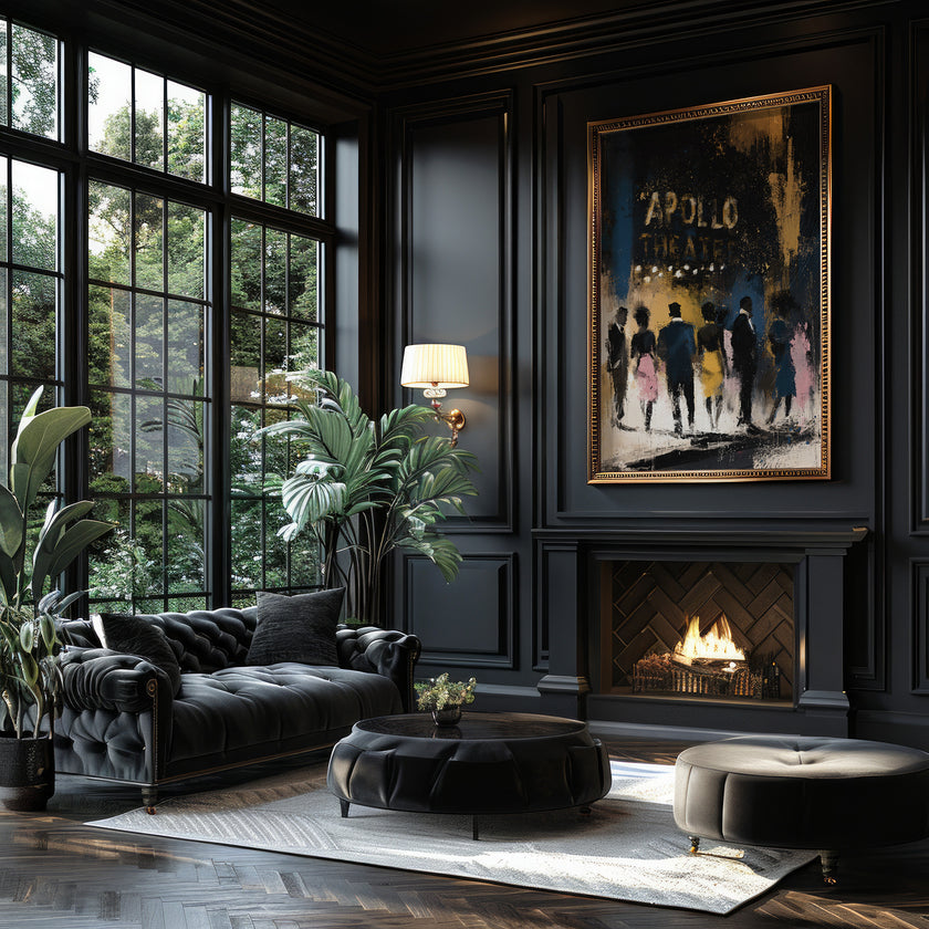 A luxurious dark living room featuring a black tufted chaise lounge, a round ottoman, a black coffee table, and a large framed Apollo Theatre fine art print on a black paneled wall above a fireplace.