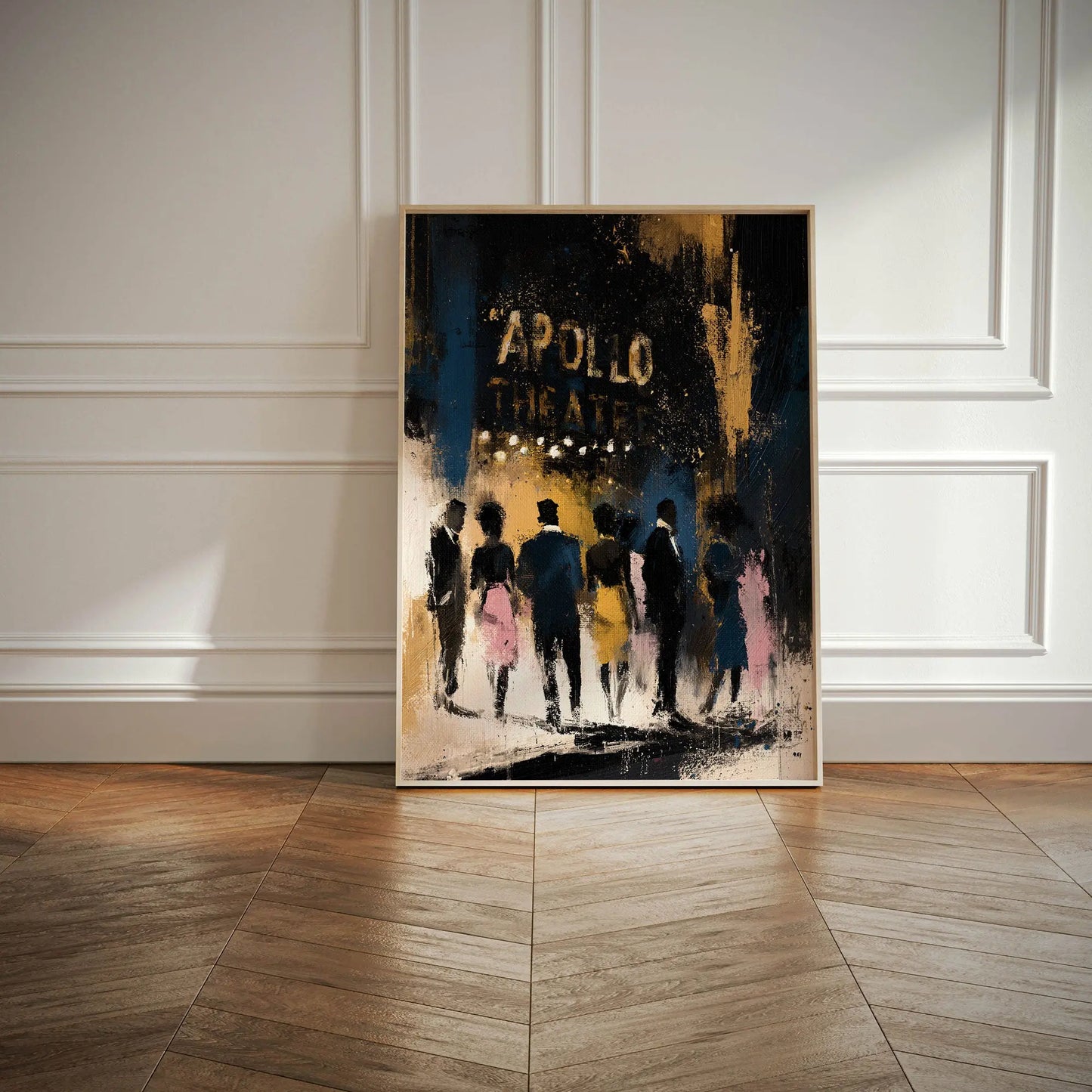 A framed vertical art print leaning against a white paneled wall on a wood floor. The artwork depicts silhouetted figures walking toward the Apollo Theatre in gold against a dark blue, black, and gold background.