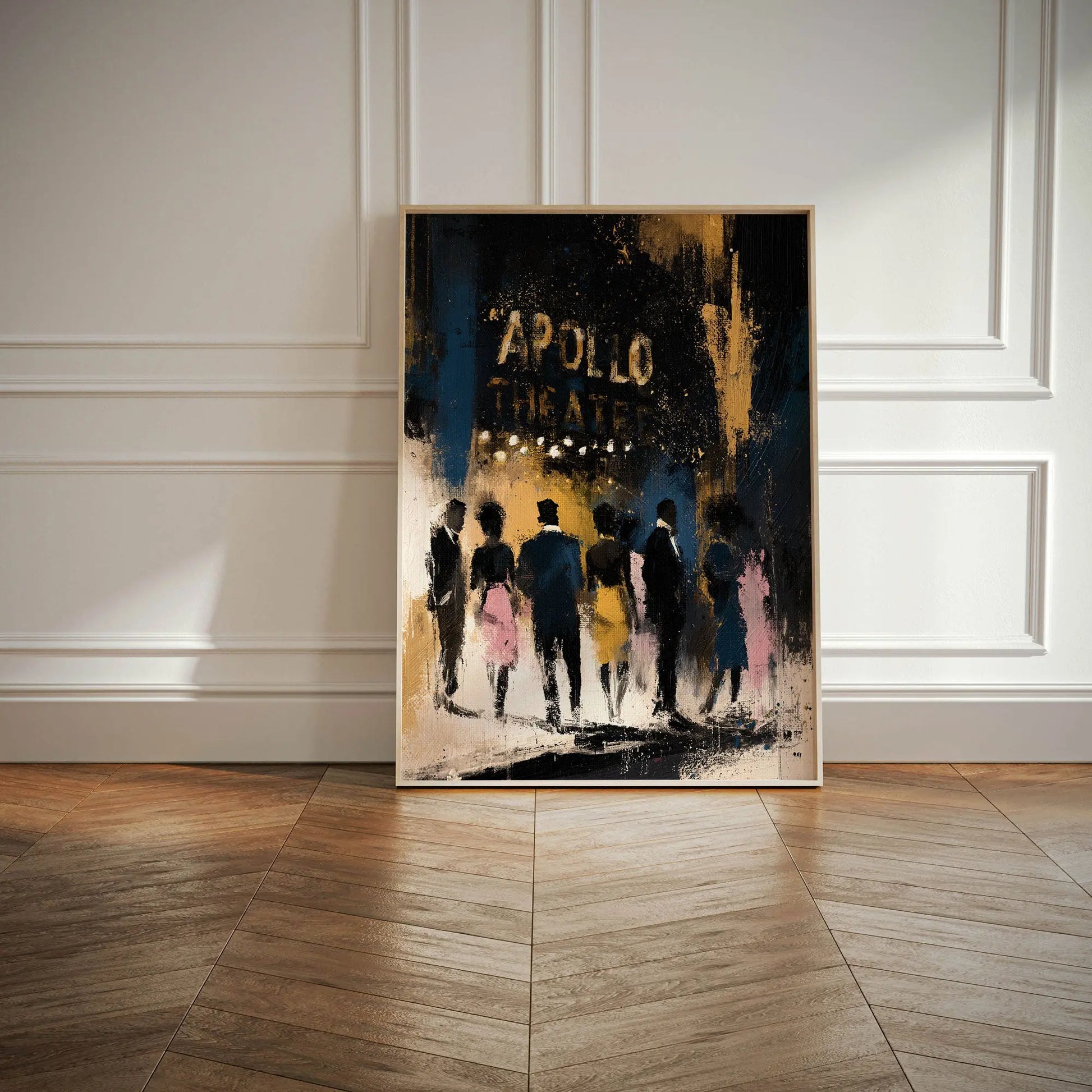 A framed vertical art print leaning against a white paneled wall on a wood floor. The artwork depicts silhouetted figures walking toward the Apollo Theatre in gold against a dark blue, black, and gold background.