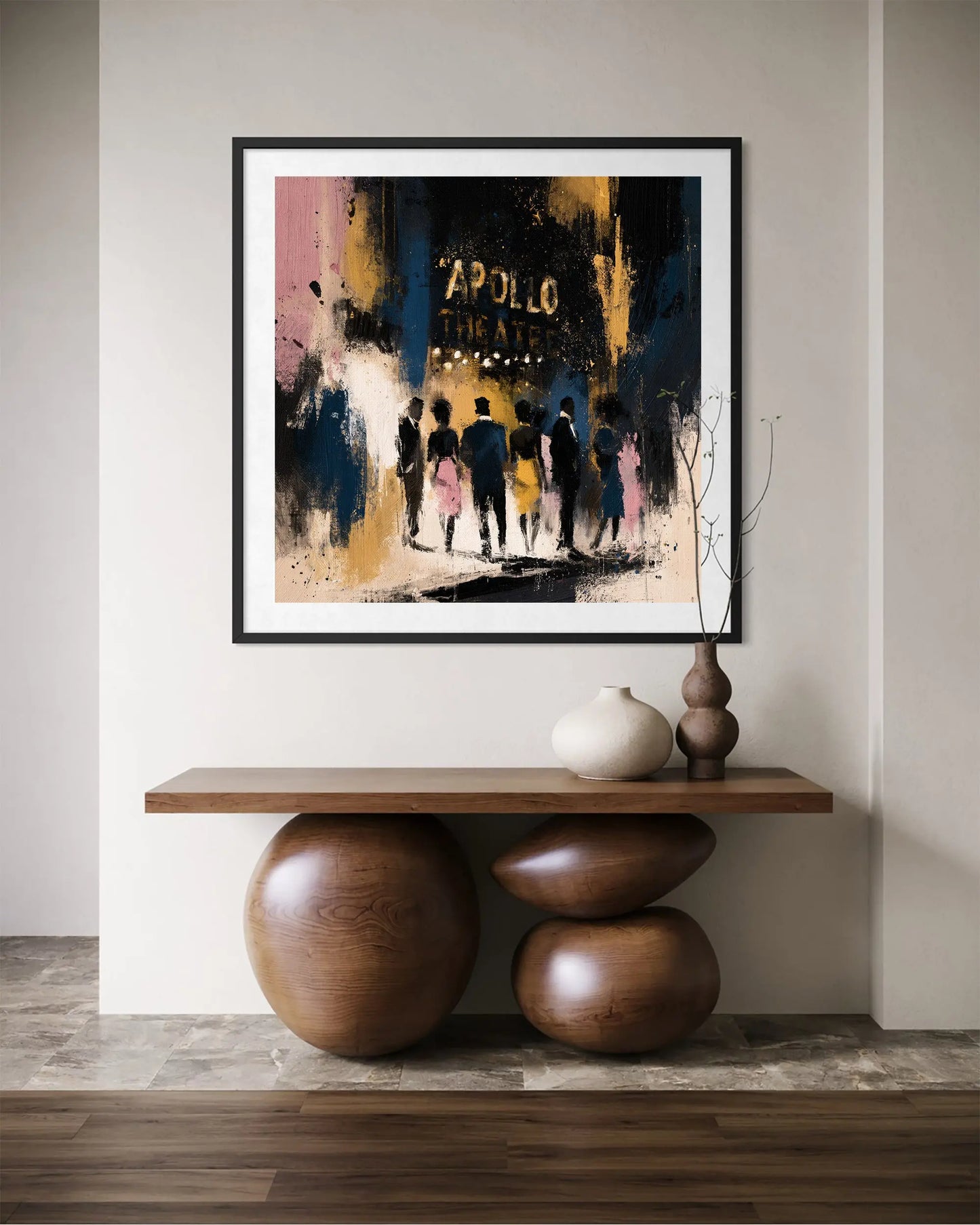 A framed abstract art print depicting silhouettes of people at night under the words 'APOLLO THEATRE', displayed on a wall above a wooden console table with decorative vases.