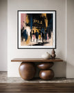 A framed abstract art print depicting silhouettes of people at night under the words 'APOLLO THEATRE', displayed on a wall above a wooden console table with decorative vases.