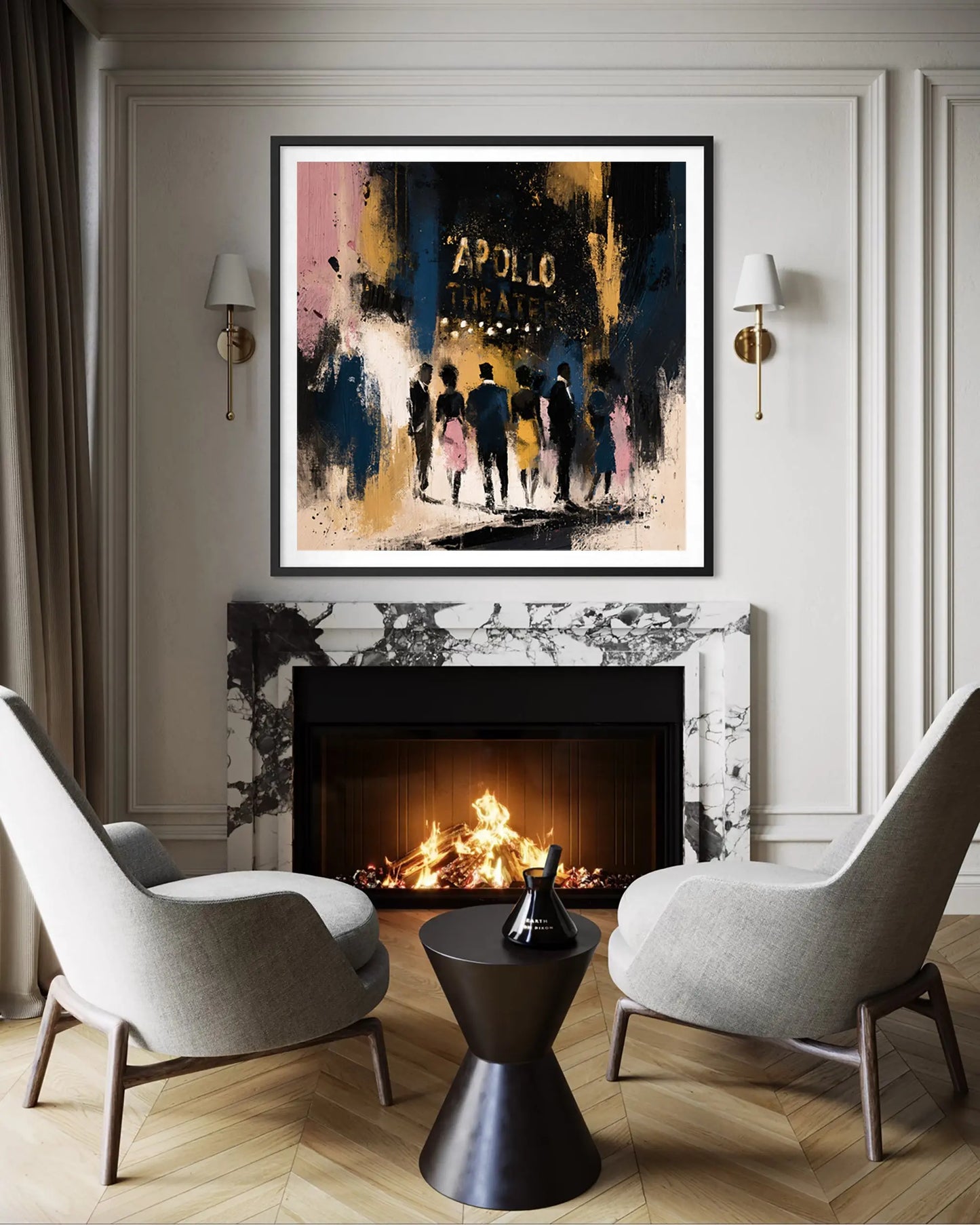 A framed abstract art print featuring the historic Apollo Theatre and silhouetted figures, displayed above a fireplace in a modern living room setting with two gray armchairs and a black side table.