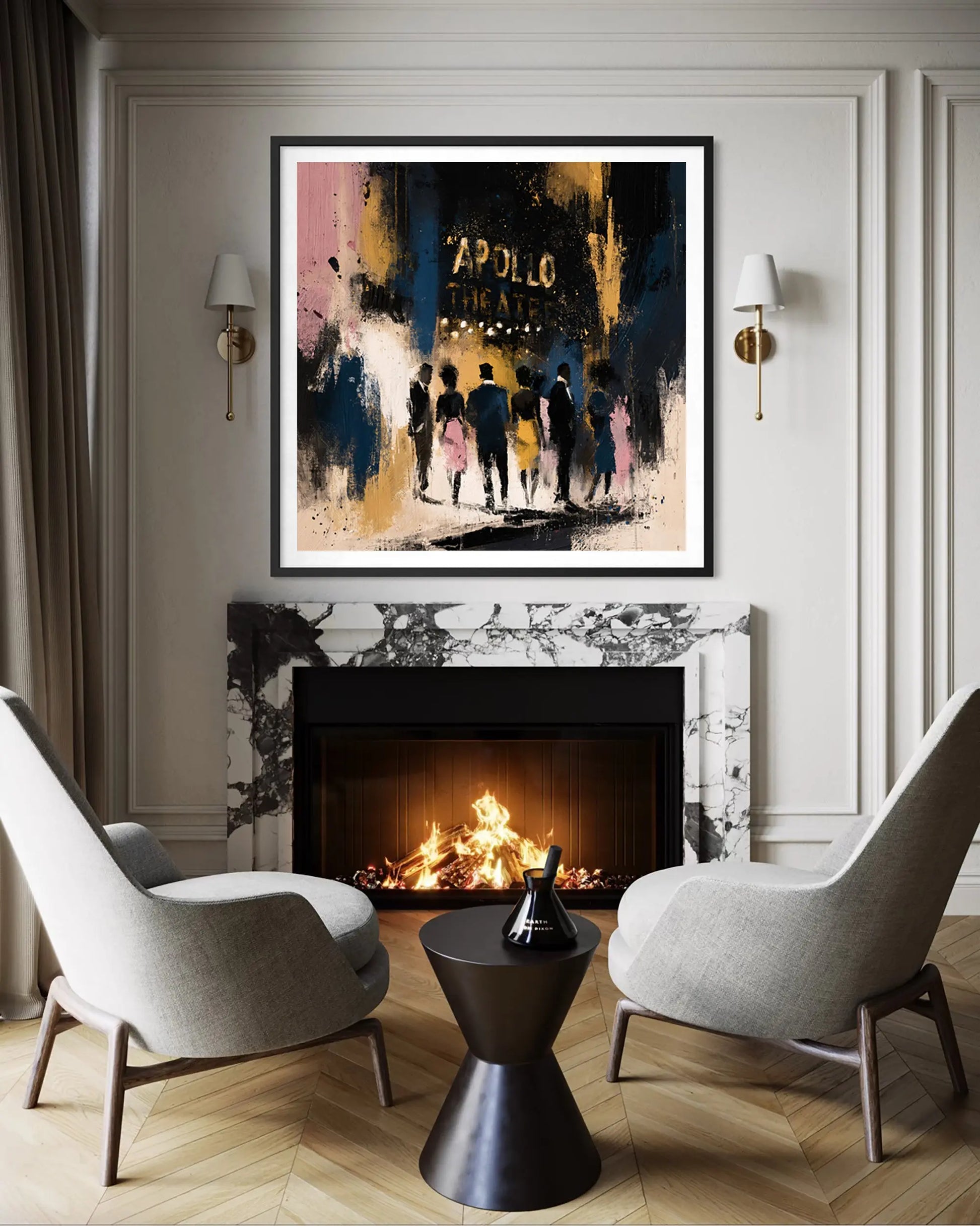 A framed abstract art print featuring the historic Apollo Theatre and silhouetted figures, displayed above a fireplace in a modern living room setting with two gray armchairs and a black side table.
