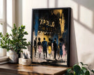 A framed art print leaning on a wooden windowsill in a bright room. The print features an abstract painting of figures walking towards the 'APOLLO THEATER' in distressed gold lettering.