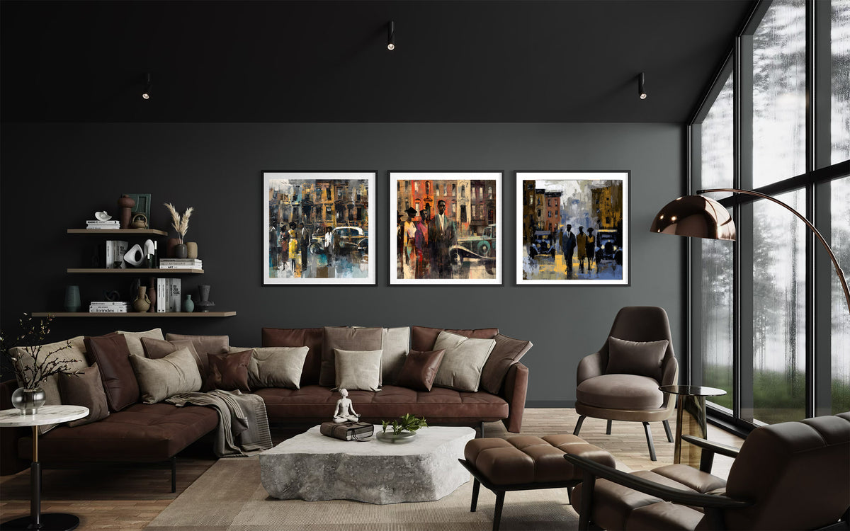 Three framed Harlem vintage styled art prints depicting colorful city street scenes, displayed in a modern loft living room setting above a dark brown leather sofa.