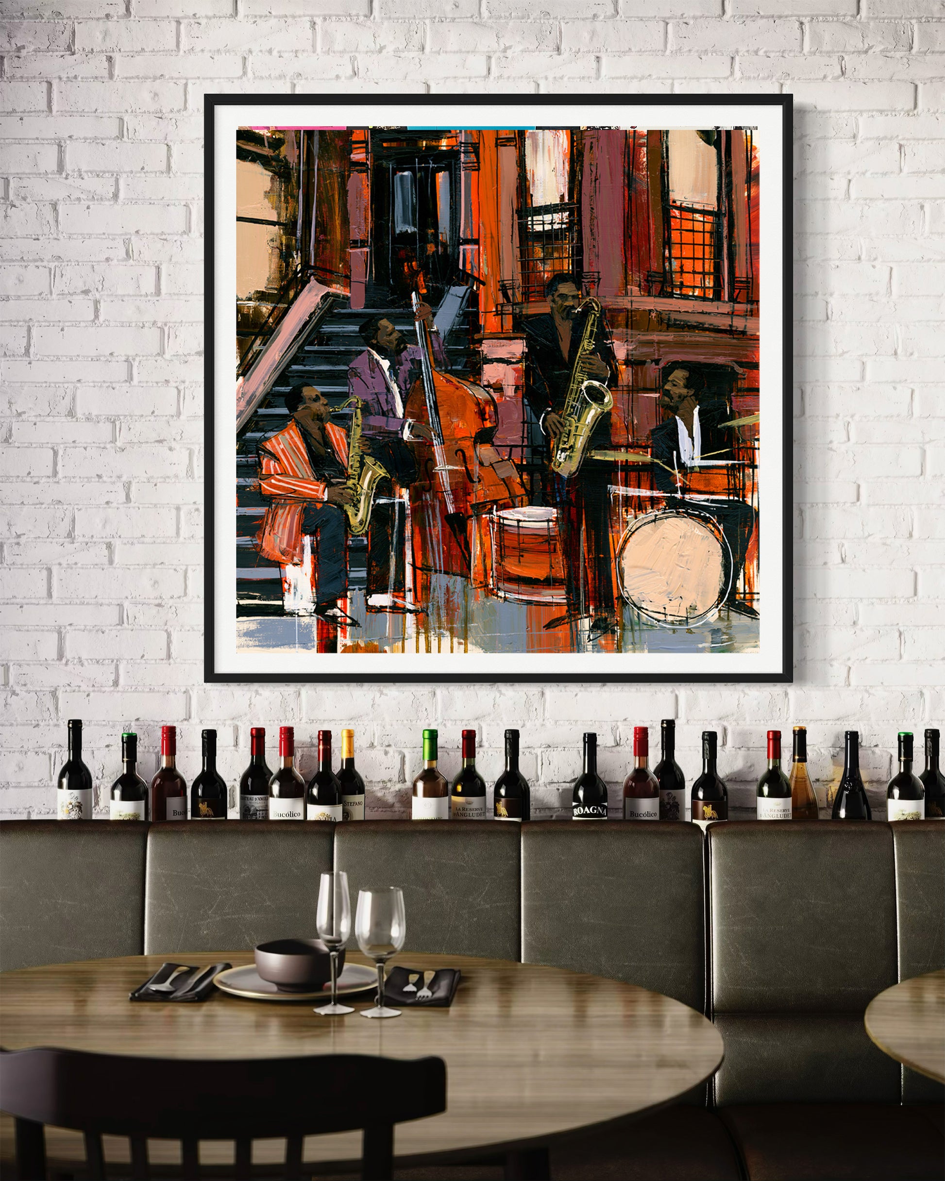 A framed abstract jazz music painting hangs on a white brick wall above a restaurant booth lined with wine bottles. The artwork features jazz musicians playing on the sidewalk in front of Harlem's historic brownstone buildings.
