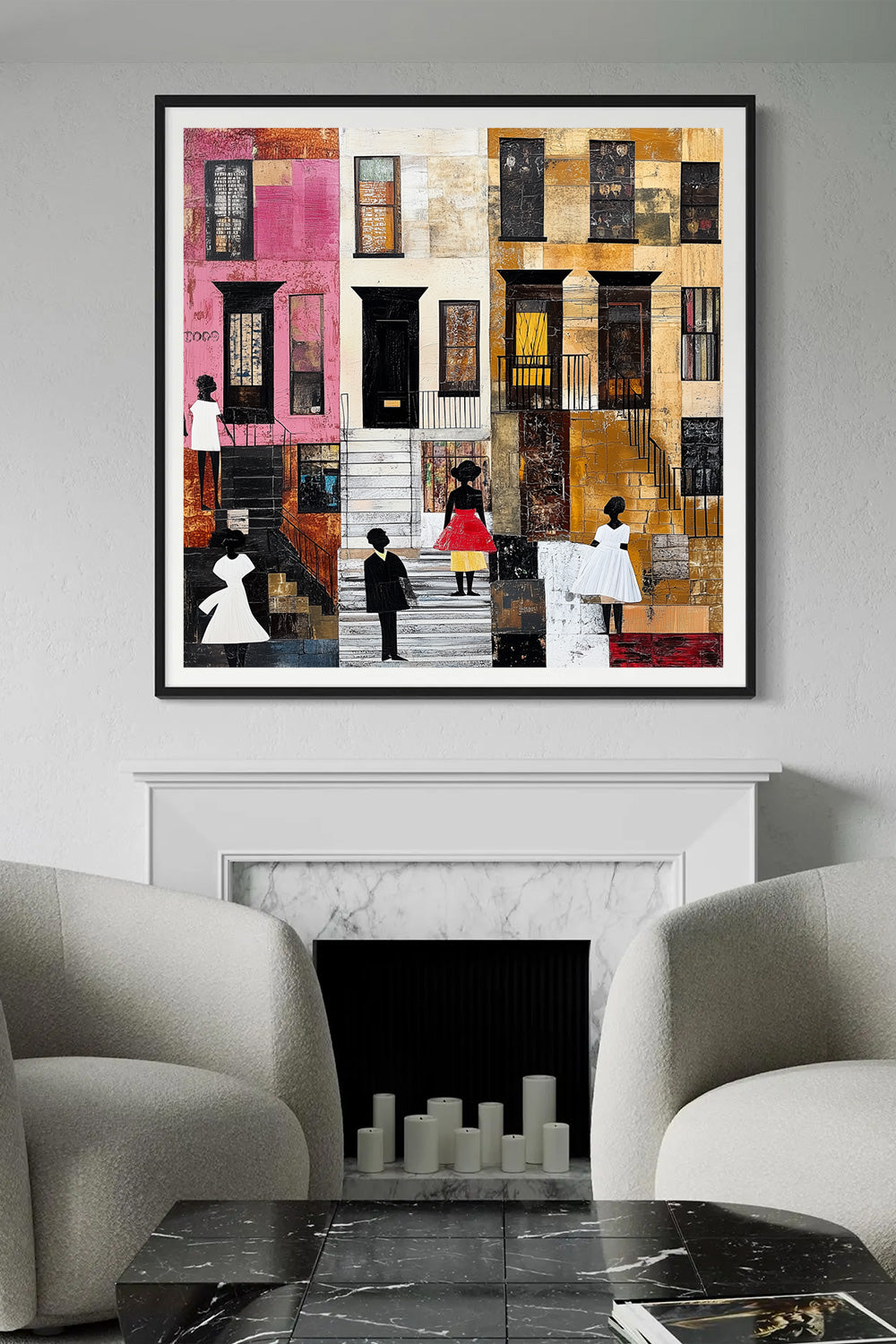 A framed wall art print depicting a colorful city street scene with stylized buildings and small human figures, displayed above a white fireplace in a modern living room with two gray armchairs and a black marble coffee table.
