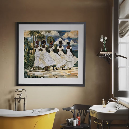 Video of a fine art print depicting Afrocentric Gullah Geechee women dressed in white faux quilt-style patter dresses celebrating Black Lowcountry coastal heritage, African American ancestry, cultural traditions, family, community, and life rooted by the sea. Image is displayed on a light gray wall next to a potted bonsai tree.
